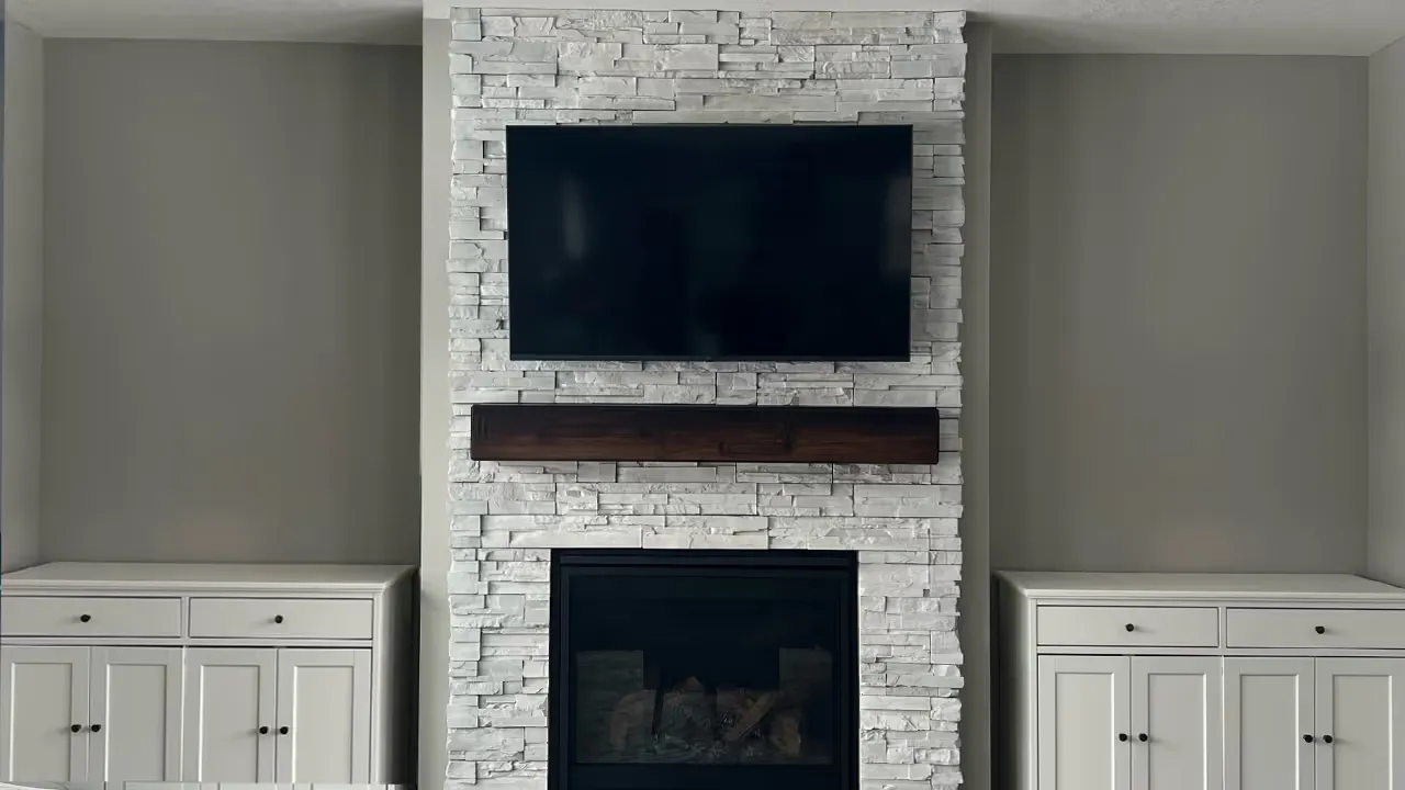 A 55-inch TV mounted on a stone fireplace