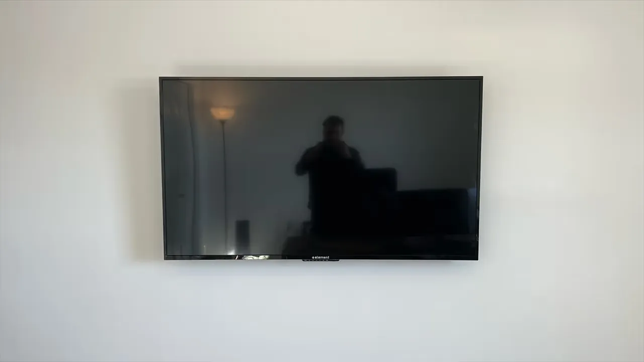 A 55-inch TV with the cords concealed inside the wall