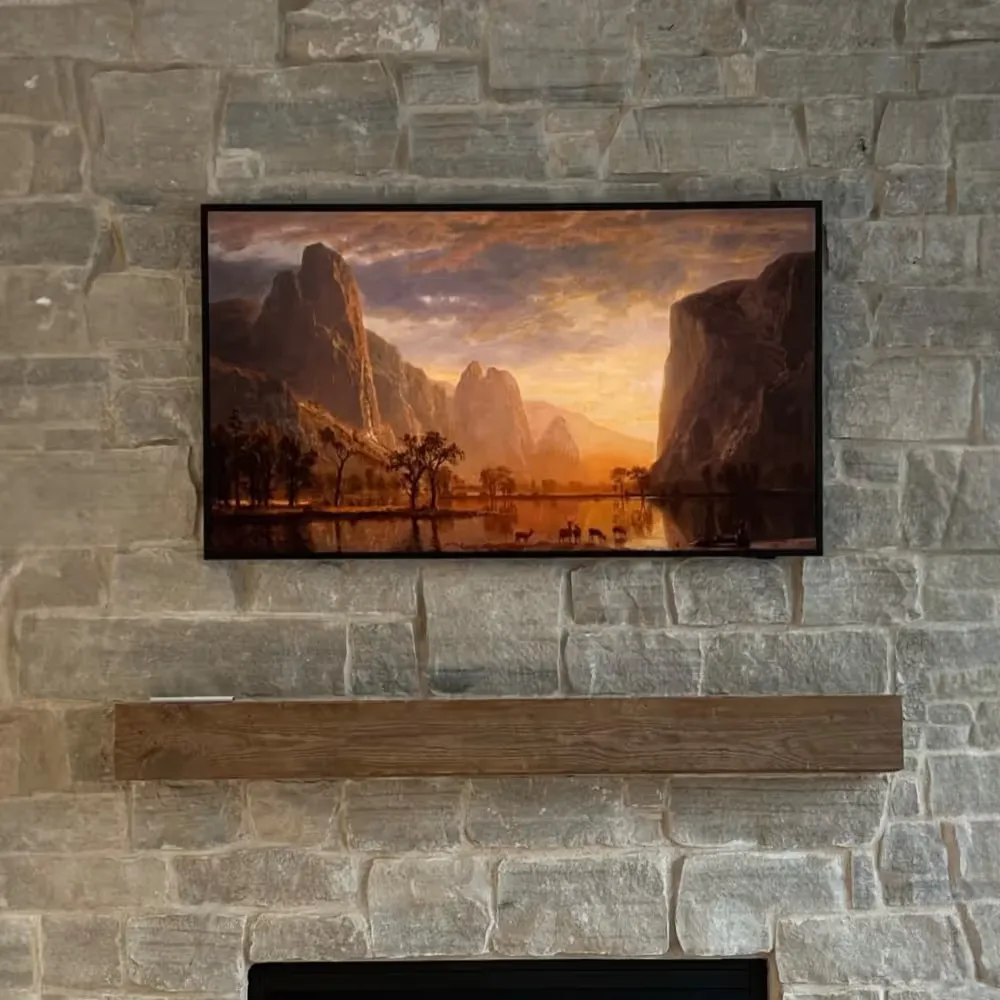 Samsung Frame mounted on brick above a fireplace for PJ Tucker in Houston