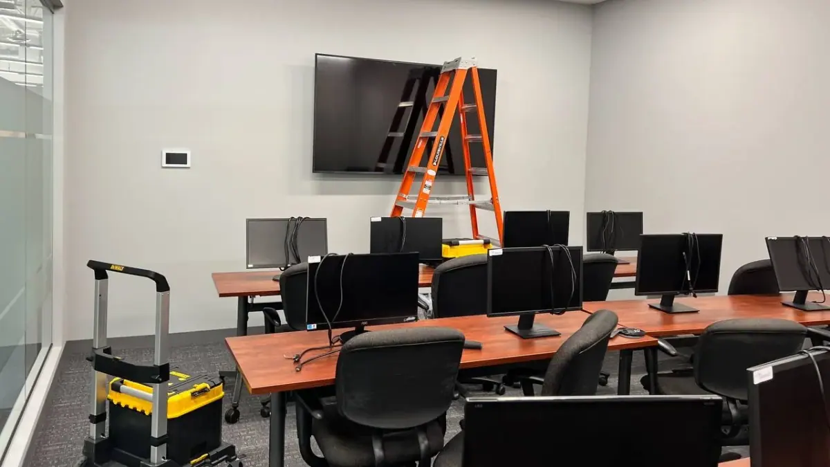86-inch TV mounted in Plymouth office training room on Vicksburg Lane with steel stud mounting