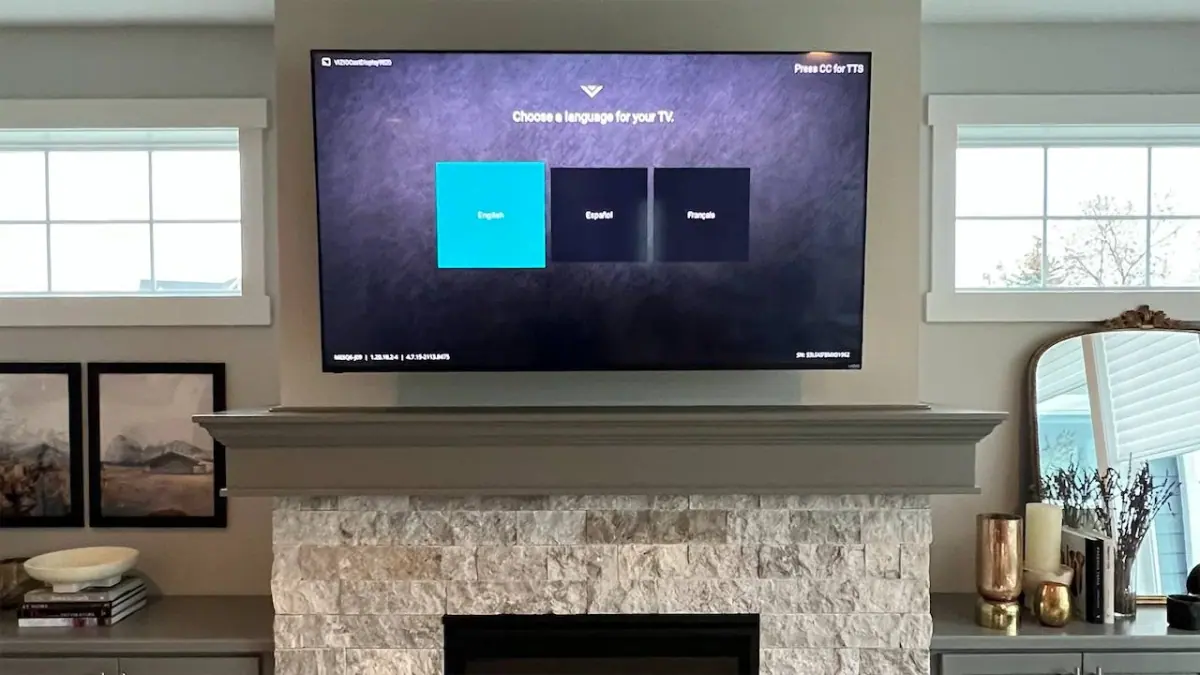75-inch TV mounted above stone fireplace in Plymouth with cavity cable routing