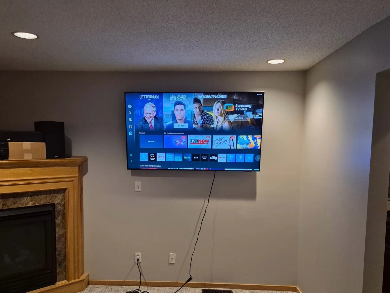 65-inch TV mounted on drywall with tilt bracket in Mound