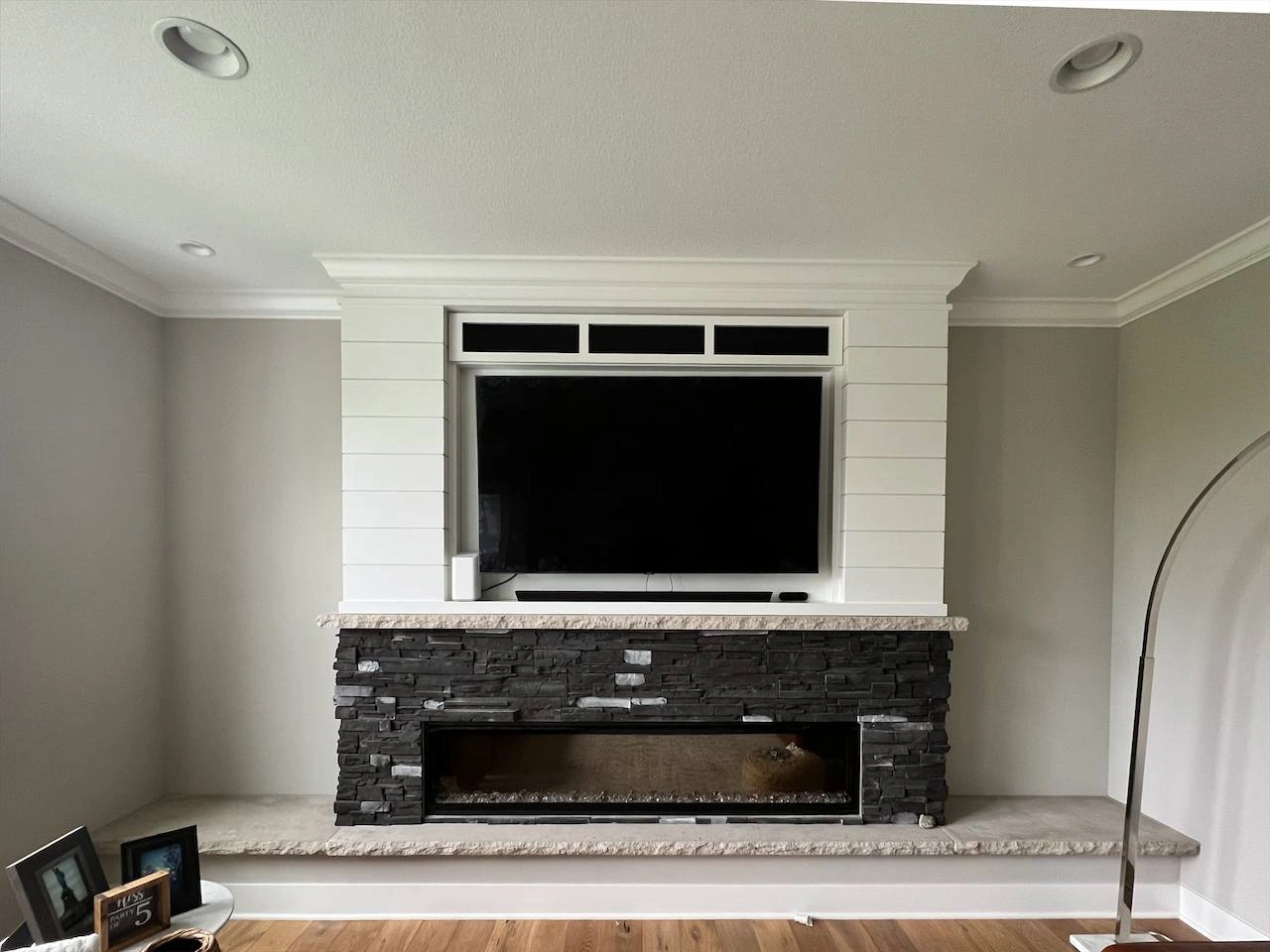 75-inch TV mounted in custom fireplace nook in Medina Minnesota with full-motion bracket