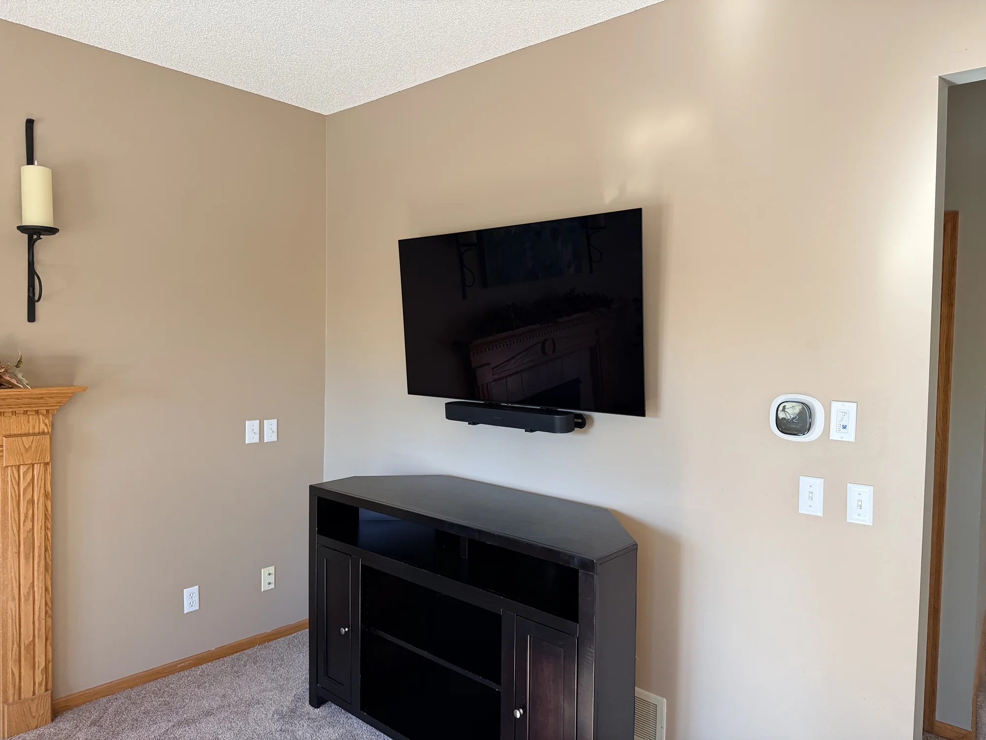 Cord concealment behind a wall-mounted TV in Chaska