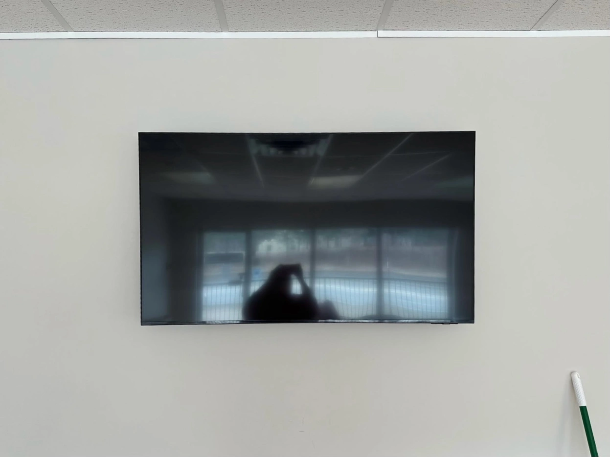 55-inch TV mounted on tilt bracket in New Brighton commercial space
