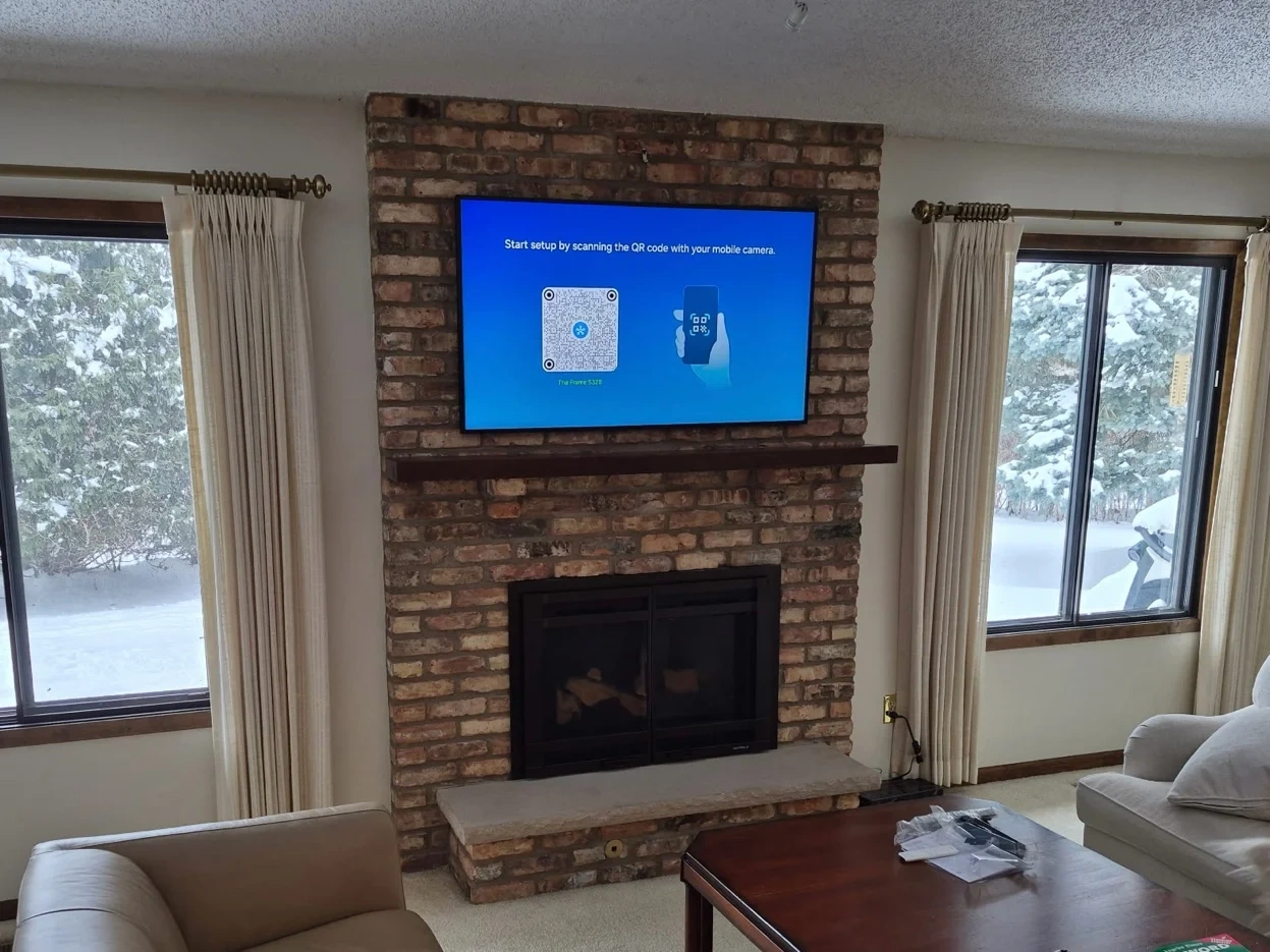 65-inch Samsung Frame TV mounted on brick fireplace in Wayzata