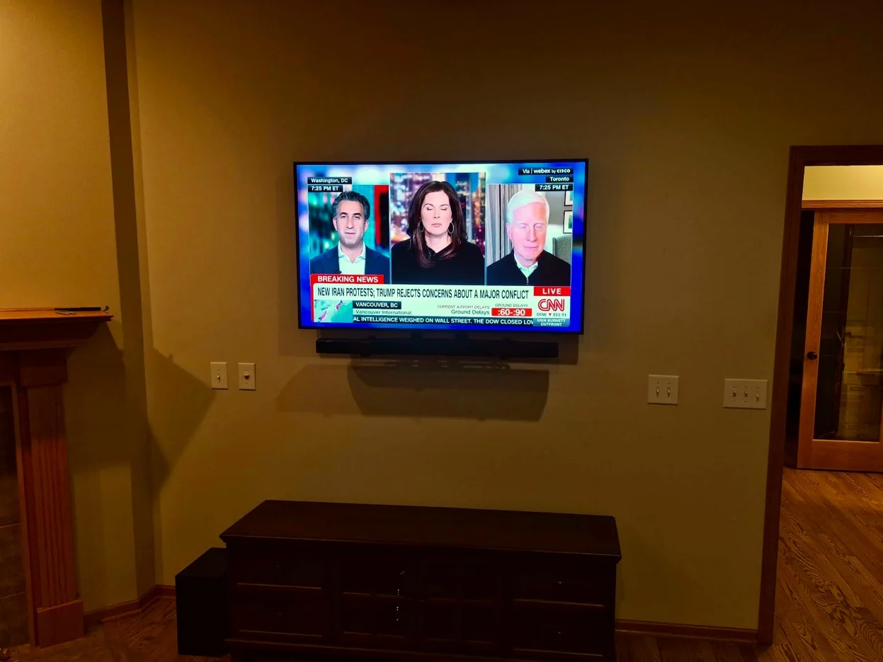 55-inch TV with soundbar mounted on drywall with tilt bracket in Woodbury
