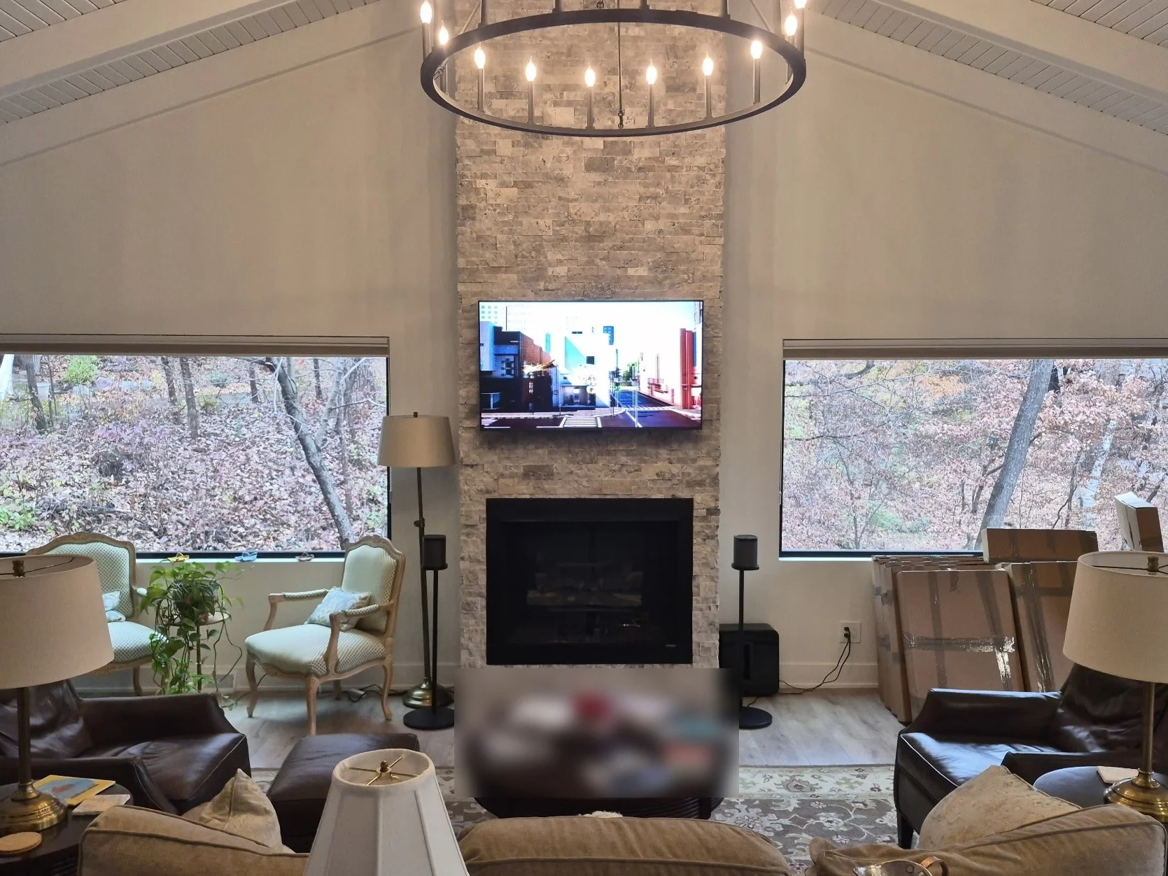 65-inch TV on a MantelMount above a stacked stone fireplace in Minneapolis