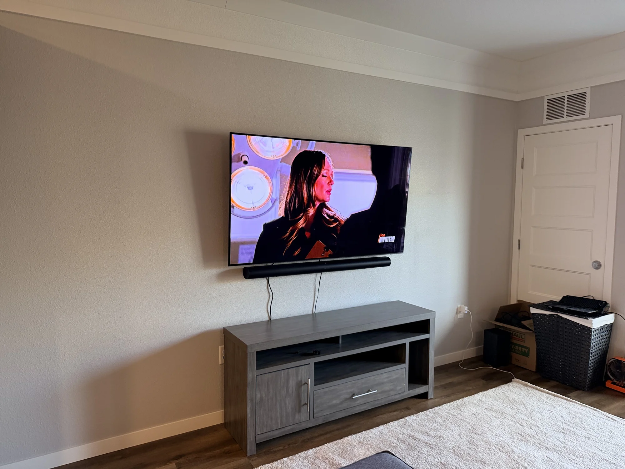 65-inch Samsung TV on a full-motion mount with a Sonos Arc soundbar mounted below in Woodbury